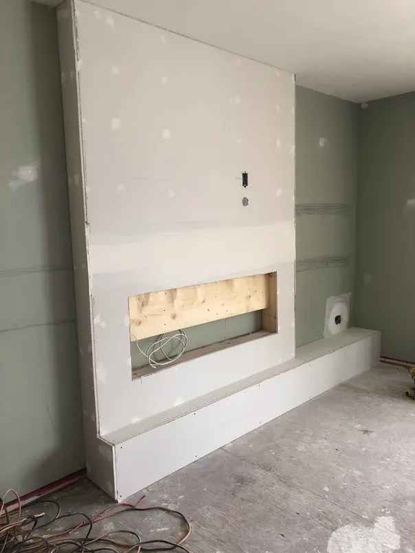 photo of the fireplace in the "Barker" feature wall designed and built by KMA Building in Winnipeg, MB