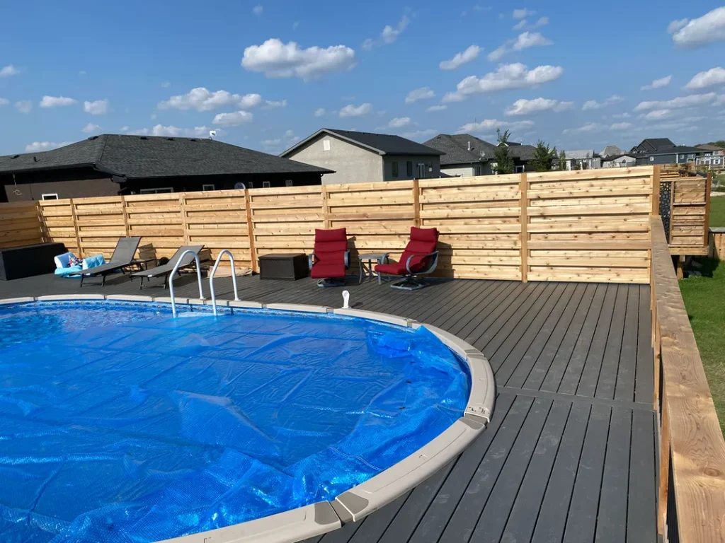 photo of the "Heloise" deck, a composite swimming pool deck designed and built by KMA Building in Winnipeg, MB