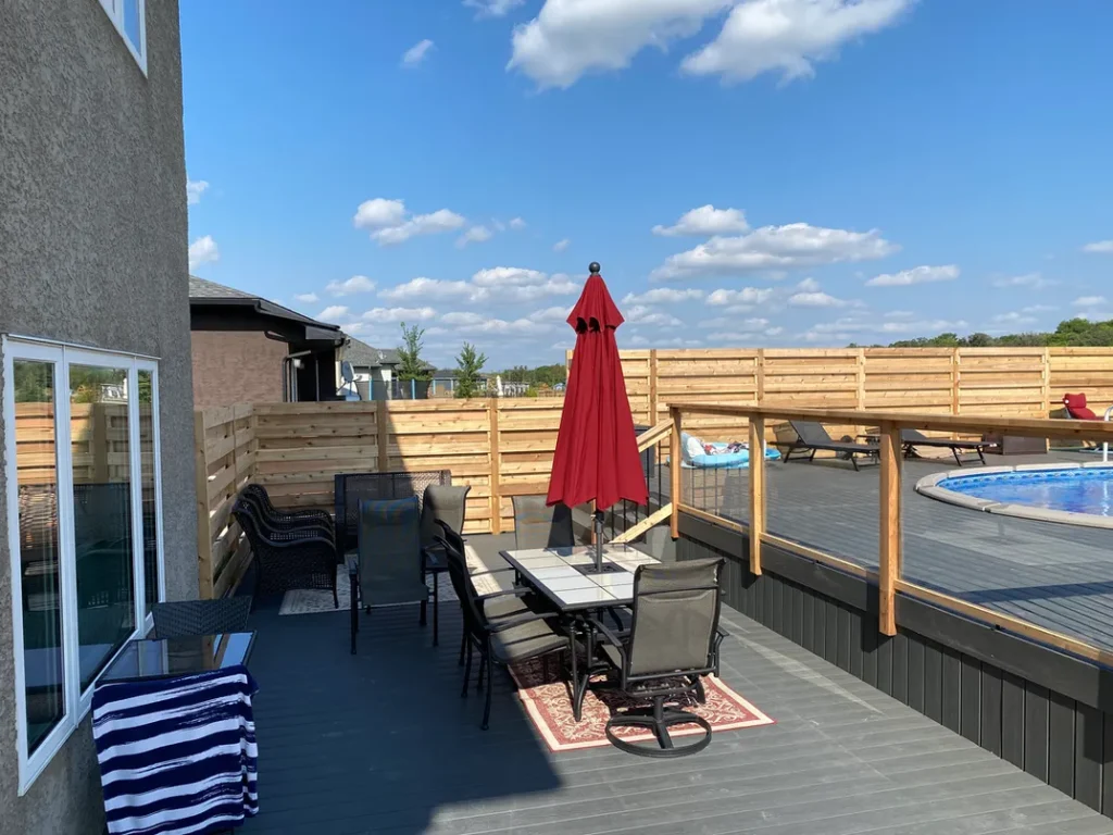 photo of the "Heloise" deck, a composite swimming pool deck designed and built by KMA Building in Winnipeg, MB